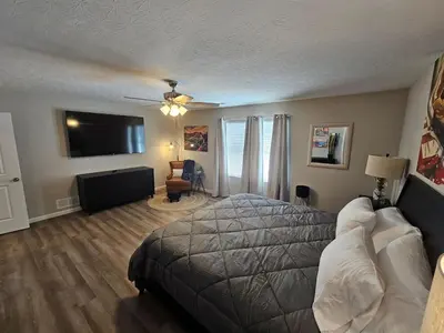 a bedroom with a bed and a flat screen tv at Vroooom . . . . the ROAD is calling. . . . in Trenton