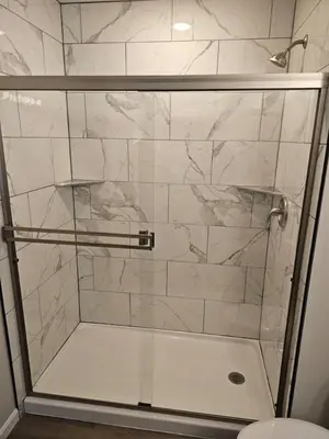 a shower with a glass door in a bathroom at Vroooom . . . . the ROAD is calling. . . . in Trenton