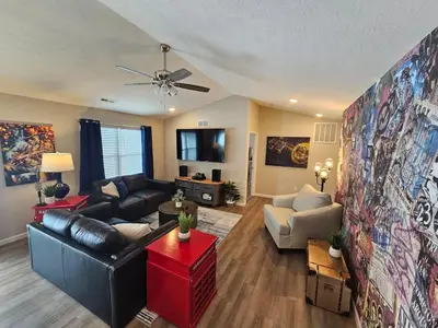a living room with a couch and a table at And . . . . the Beat Goes On in Trenton