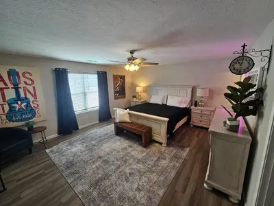 a living room with a bed and a couch at And . . . . the Beat Goes On in Trenton