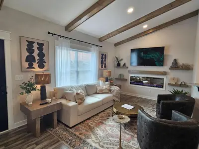 a living room with a couch and a tv at Upscale New Construction Ranch in Middletown