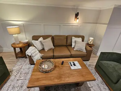 a living room with a couch and a coffee table at Upscale New Construction Ranch in Middletown