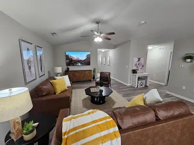 a living room with a couch and a table at Cozy Charming Cottage-Style Home in Hamilton