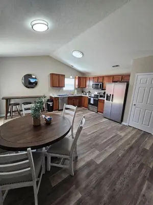 a kitchen and dining room with a table and chairs at Cozy Charming Cottage-Style Home in Hamilton