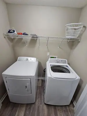 a laundry room with a washing machine and a washer at Cozy Charming Cottage-Style Home in Hamilton