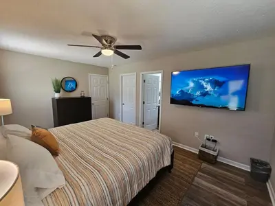 a bedroom with a bed and a ceiling fan at Cozy Charming Cottage-Style Home in Hamilton