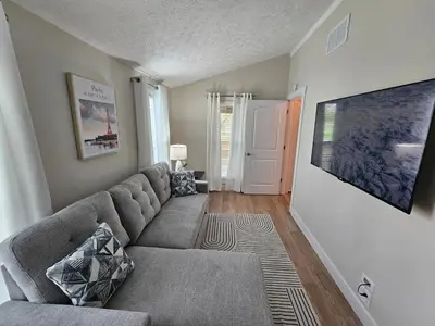 a living room with a couch and a tv at Quaint Liberty Township Remodeled Home in Hamilton