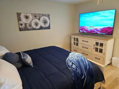 a bedroom with a bed and a flat screen tv at Quaint Liberty Township Remodeled Home in Hamilton
