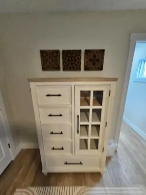 a white cabinet in the corner of a room at Quaint Liberty Township Remodeled Home in Hamilton