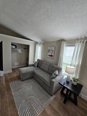 a living room with a couch and a table at Quaint Liberty Township Remodeled Home in Hamilton