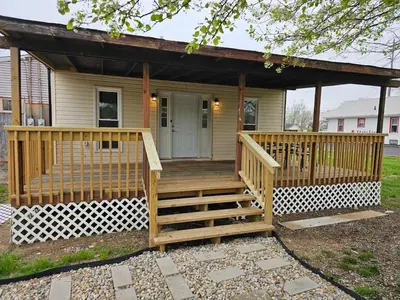 a small house with a porch and a deck at Quaint Liberty Township Remodeled Home in Hamilton