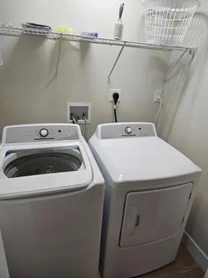 a laundry room with a washing machine and a washer at Quaint Liberty Township Remodeled Home in Hamilton