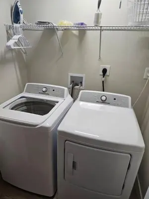 a laundry room with a washer and dryer at Quaint Liberty Township Remodeled Home in Hamilton