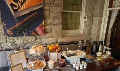 a table with bread and other food items on it at Willoughby House Inn in Willoughby