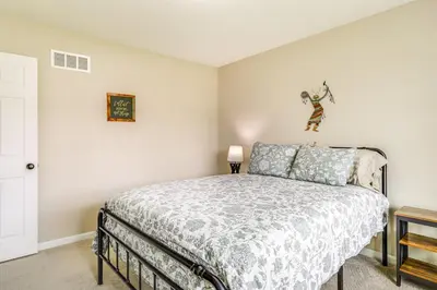 a bedroom with a king sized bed in a room at 8 Mi to Ark Encounter Family Home with Deck and Grill in Dry Ridge