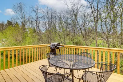 a table and chairs on a wooden deck at 8 Mi to Ark Encounter Family Home with Deck and Grill in Dry Ridge