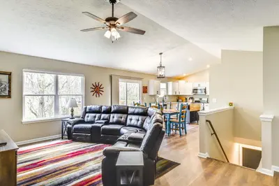 a living room with a couch and a table at 8 Mi to Ark Encounter Family Home with Deck and Grill in Dry Ridge