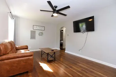 a living room with a couch and a ceiling fan at New Charloe Court 3 Bed Family House in Cincinnati