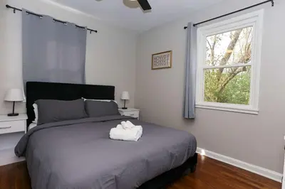 a bedroom with a large bed with a window at New Charloe Court 3 Bed Family House in Cincinnati