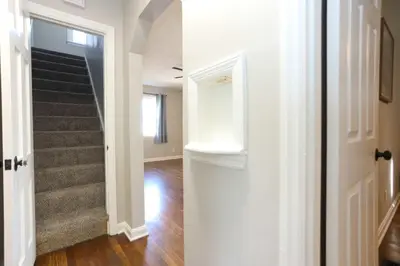 a hallway of a house with a stairway at New Charloe Court 3 Bed Family House in Cincinnati