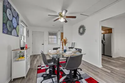a dining room and kitchen with a table and chairs at Cosy house, home away from home in Grove City