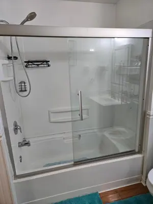 a shower with a glass door in a bathroom at Cosy house, home away from home in Grove City