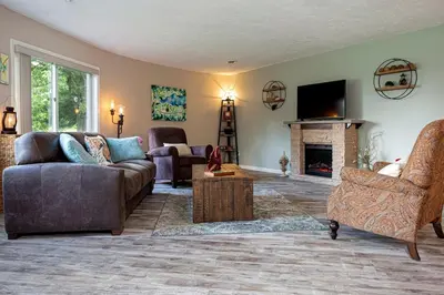 a living room with a couch and a fireplace at Unique Ohio Cottage for a Weekend Getaway in the Midwest in Perrysville