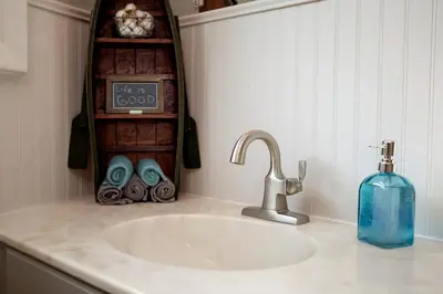 a bathroom counter with a sink and a soap dispenser at Unique Ohio Cottage for a Weekend Getaway in the Midwest in Perrysville
