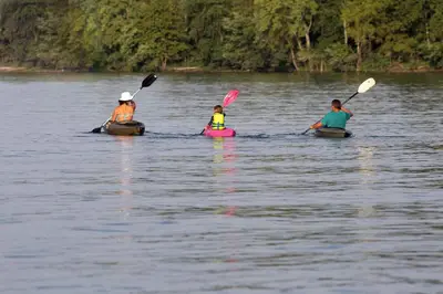 a group of three people kayaking on a lake at Unique Ohio Cottage for a Weekend Getaway in the Midwest in Perrysville