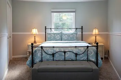 a bedroom with a bed with blue sheets and two lamps at Unique Ohio Cottage for a Weekend Getaway in the Midwest in Perrysville