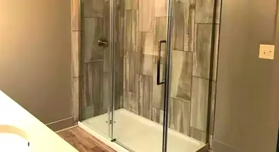 a shower with a glass door in a bathroom at Stunning Rustic Converted Barn Country Getaway near Wabash, Indiana in Wabash