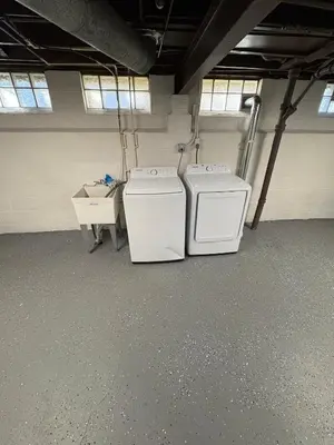 two washing machines are sitting in a garage at Cozy Euclid Home Near Lakefront in Euclid