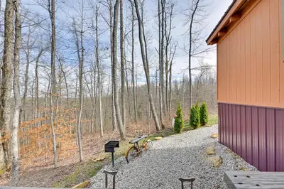 a bike parked on a gravel path next to a building at Bring a Pet Peaceful Frenchburg Cabin on 1 Acre in Frenchburg