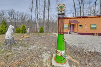 a statue of a green bottle in front of a building at Bring a Pet Peaceful Frenchburg Cabin on 1 Acre in Frenchburg