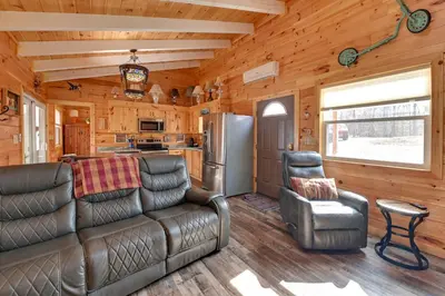 a living room with leather furniture in a log cabin at Bring a Pet Peaceful Frenchburg Cabin on 1 Acre in Frenchburg