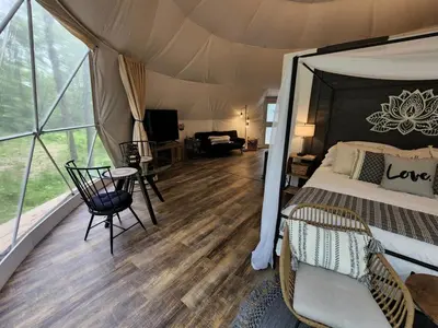 a bedroom with a bed in a tent at Bunny Bungalow Romantic Getaway in a Spacious Geodome in New Straitsville