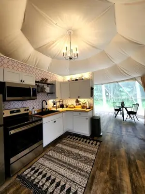 a kitchen with a large ceiling with a rug on the floor at Bunny Bungalow Romantic Getaway in a Spacious Geodome in New Straitsville