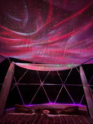 a stage with a purple and pink curtain at Bunny Bungalow Romantic Getaway in a Spacious Geodome in New Straitsville