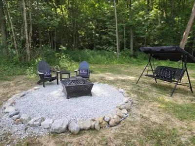 a fire pit with three chairs and a grill at Bunny Bungalow Romantic Getaway in a Spacious Geodome in New Straitsville