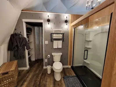 a bathroom with a toilet and a shower and a sink at Bunny Bungalow Romantic Getaway in a Spacious Geodome in New Straitsville