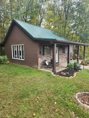 a small house with a green roof at Deer Haven Cabin in New Straitsville