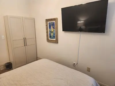 a bedroom with a bed and a flat screen tv on the wall at Schwartz Castle in Columbus