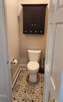 a bathroom with a toilet and a cabinet at Schwartz Castle in Columbus