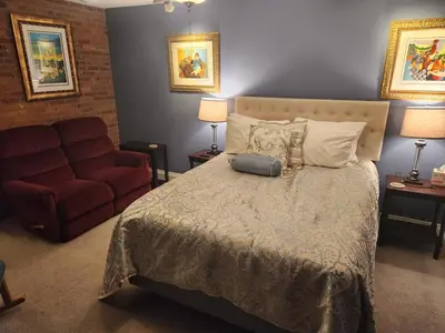 a bedroom with a bed and a red couch at Schwartz Castle in Columbus