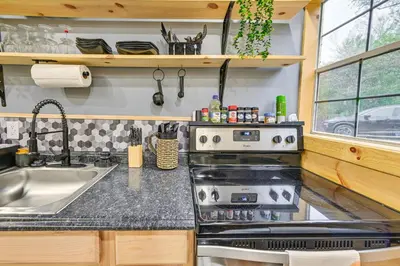 a kitchen with a stove and a sink at Hot Tub, Fire Pit Lake-View Catlettsburg Getaway! in Catlettsburg