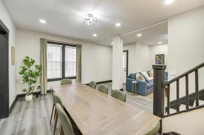 a dining room with a table and a couch at 4 Mi to Dtwn Modern Retreat with Yard in Cleveland in Cleveland