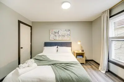 a bedroom with a large bed and a window at 4 Mi to Dtwn Modern Retreat with Yard in Cleveland in Cleveland