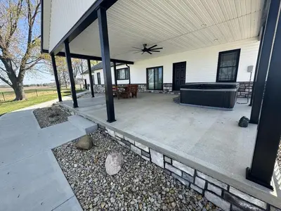 a screened in porch of a house with a tub at Country Cornerstone Retreat - Game Room, Theater, Hot Tub, Massage Chairs, Gym, Grill, Sauna, Fire Pit in Hillsboro
