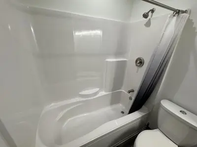 a white bathroom with a tub and a toilet at Country Cornerstone Retreat - Game Room, Theater, Hot Tub, Massage Chairs, Gym, Grill, Sauna, Fire Pit in Hillsboro