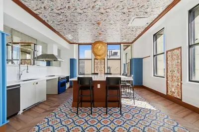 a kitchen with a table and chairs and windows at CozySuites at Sky Central in Cincinnati